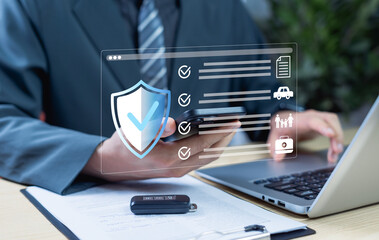 Businessman reviewing online documents for car insurance and family protection policies. Concept of business technology, quality assurance standards, and digital document management.