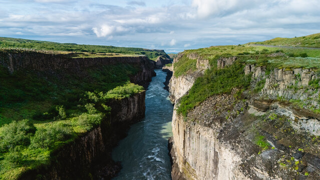 Breathtaking aerial view of a dramatic canyon landscape in Iceland under vibrant skies