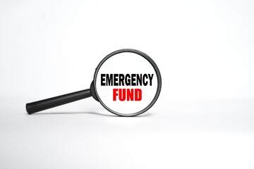 Emergency Fund said in a magnifying glass. bright white background.