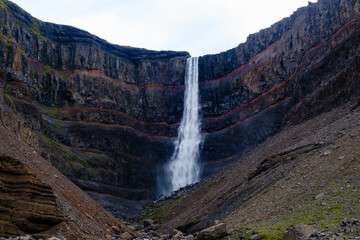 Hengifoss waterfall cascades down rugged cliffs in Icelands stunning landscape