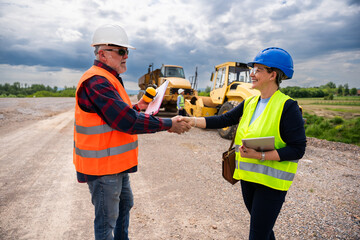Highway engineers discuss and plan.They shake hands.