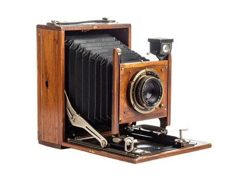 Vintage wooden bellows camera isolated on a white background, front view.