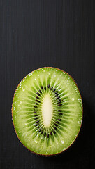 One sliced kiwi fruit with water droplets on matte black background, vivid green, clean layout, vertical imagemobile wallpaper.