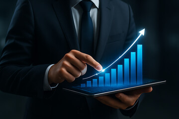 Businessman analyzing financial data on tablet with glowing rising bar chart and upward arrow, symbolizing profit growth, economic success, and performance increase in business