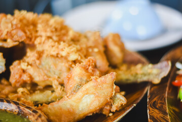 Close-up of fried food. Crispy fried fish or seafood pieces coated in batter and deep-fried until...