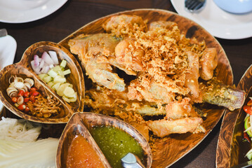Close-up of fried food. Crispy fried fish or seafood pieces coated in batter and deep-fried until...