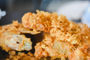 Close-up of fried food. Crispy fried fish or seafood pieces coated in batter and deep-fried until...
