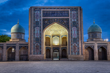 Tashkent, Uzbekistan - 05 April 2024: View of the serene Hazrati Imam Complex, with its turquoise domes and intricate tilework glowing softly against the twilight sky.