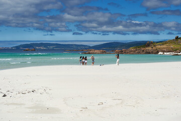 Visitors and tourists on the white sand at Pindo Beach