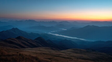 Obraz premium Scenic view of a mountain landscape during sunrise, no people in sight. 