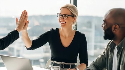 Two diverse colleagues celebrate a successful business deal with a high five in a modern office - Powered by Adobe