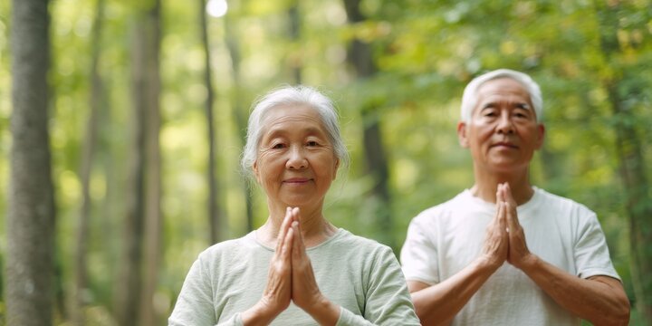 Diversity in Exercise & Wellness meditation concept. Two seniors practicing mindfulness in a serene forest setting.