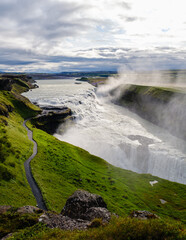 Majestic Gullfoss waterfall cascading into a river valley in Iceland during golden hour