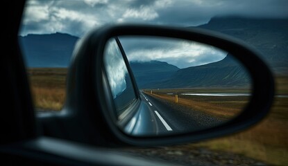 Scenic view reflected in a car mirror