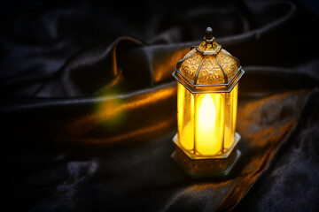 Islamic lanterns isolated on a dark background, the concept of Ramadan, Eid al-Fitr, and other Islamic holidays. Stunning Ramadan candle lanterns with free space