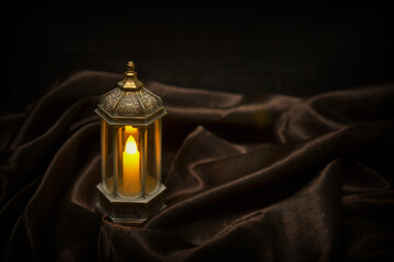 Islamic lanterns isolated on a dark background, the concept of Ramadan, Eid al-Fitr, and other Islamic holidays. Stunning Ramadan candle lanterns with free space