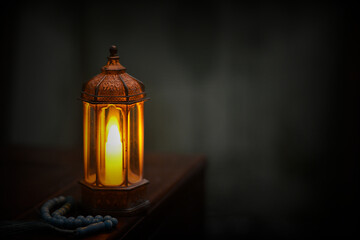 Islamic lanterns isolated on a dark background, the concept of Ramadan, Eid al-Fitr, and other Islamic holidays. Stunning Ramadan candle lanterns with free space