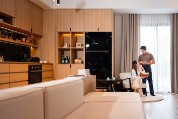 Young couple man and woman asian husband and wife in a relationship reading book hold books sits on...
