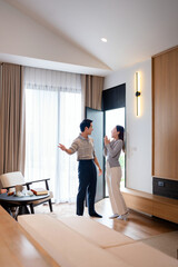 Happiness in new home. Happy married couple is having fun, hugging and sincerely rejoicing over...