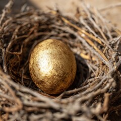 Golden Egg Nestled in a Natural Bird's Nest on a Wooden Surface