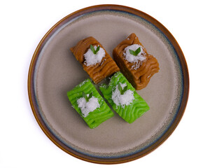 Getuk on brown plate. Getuk is a traditional Indonesian snack made from mashed boiled cassava,...