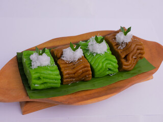 Getuk on wooden plate. Getuk is a traditional Indonesian snack made from mashed boiled cassava,...