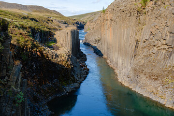 Explore the stunning formations of Studlagil Canyon in Icelands breathtaking landscape