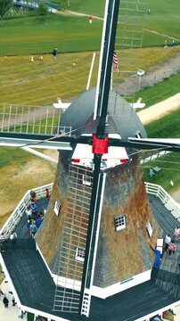 Holland, Michigan, USA 25.05.2022. Drone flies over windmill in tulip fields. Colorful landscape and historic structure mark this popular tourist location.