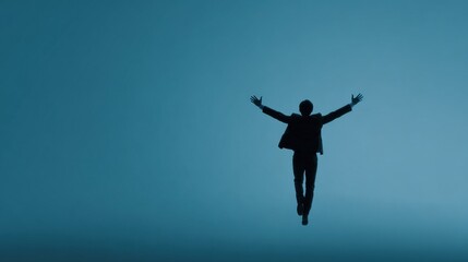 A man is jumping in the air with his arms outstretched