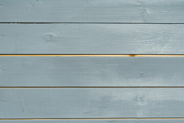 Painted wooden siding with open seam shows unpainted joint after boards shrank a year later, revealing a common facade maintenance issue.