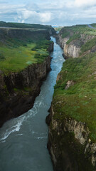 Breathtaking aerial view of a winding river through rugged cliffs in Icelands natural landscape