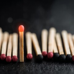 Striking Matchstick Erupts with Flame Among Standstill Matches
