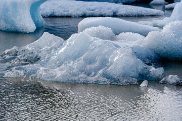 Stunning ice formations floating in the serene waters of Icelands glacial lagoon at sunrise