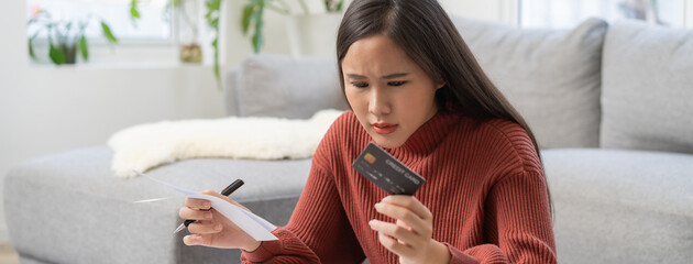 Women calculating her income and feeling anxious about paying the due for her debts.