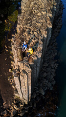 Adventure seekers enjoying the breathtaking beauty of Studlagil Canyon in Iceland