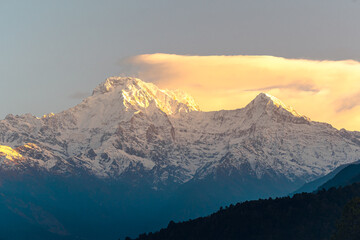 The front view of the Annapurna South peak is covered by snow on top in winter, Mardi Himal trek, Nepal. Clear sky on a sunny day. The idea for a soft-toned nature background with copy space.