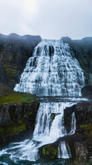Dynjandi waterfall cascading down rugged cliffs in Icelands breathtaking landscape