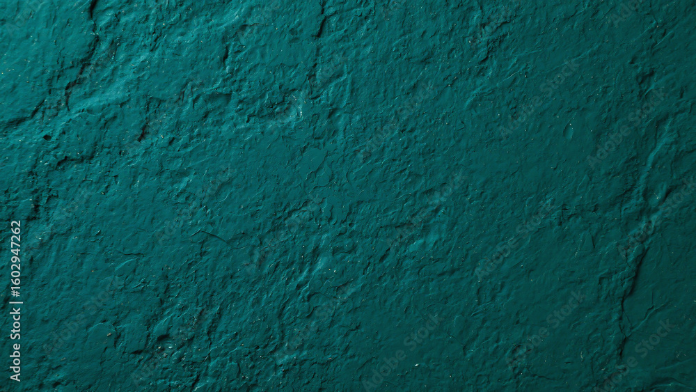 Poster close up of a teal painted wall with rough texture and uneven surface illuminated by soft light