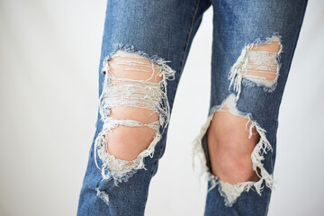 a woman in torn jeans.
