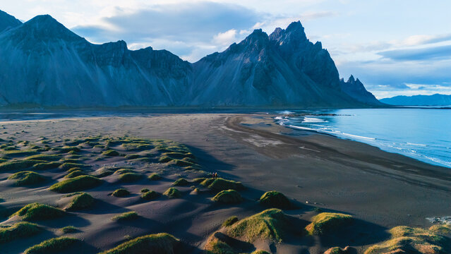 Majestic vestrahorn mountain peaks reflecting in stokksnes at twilight