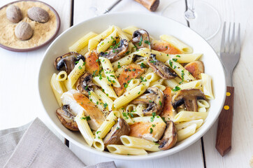 Penne pasta with chicken and mushrooms in creamy sauce. Italian cuisine. Recipe.