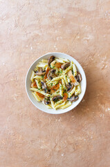 Penne pasta with chicken and mushrooms in creamy sauce. Italian cuisine. Recipe.