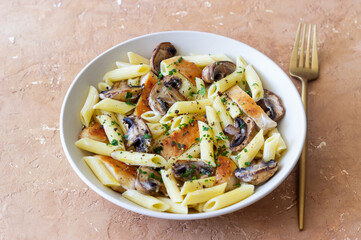 Penne pasta with chicken and mushrooms in creamy sauce. Italian cuisine. Recipe.