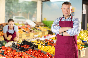 Portrait of an smiling supermarket worker in a sales floor