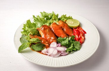 Mackerel in tomaro sauce ,Spicy Canned Mackerel salad, canned fish,Tinned fish in a white plate