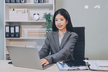 Portrait of Young Asian woman hand freelancer is working her job on computer tablet in modern...