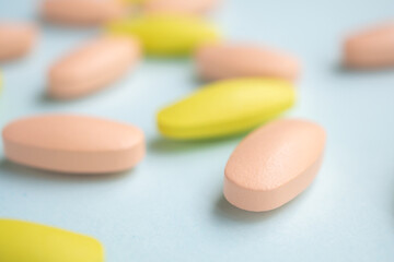 Colorful medicine pills tablet on blue background