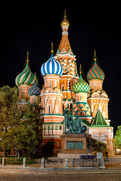 View of the vibrant, illuminated St. Basil's Cathedral rises with its iconic, colorful domes against the night sky, Moscow, Moscow, Russia.