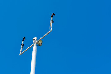 Spinning blades on an anemometer mounted on a pole