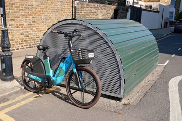 Parked electric bicycle with a distinctive camouflage design, highlighting eco friendly transportation options in an urban setting. Concept: Mobility as a Service